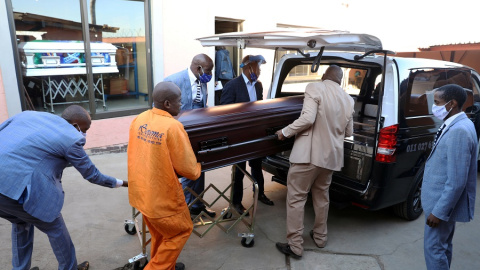 Operarios de una funeraria transportan un féretro en Sudáfrica. | REUTERS Operarios de una funeraria transportan un féretro en Sudáfrica. | REUTERS