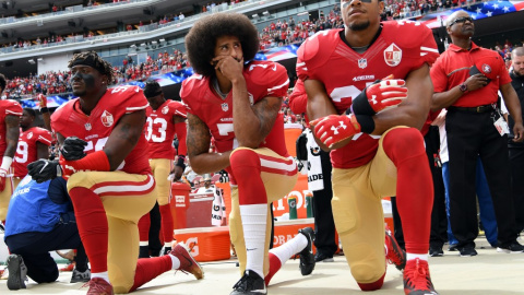 02/10/2016- Los jugadores Eli Harold, Colin Kaepernick y Eric Reid se arrodillan mientras suena el himno de EEUU durante un partido en señal de protesta en 2016. / GETTY IMAGES A TRAVÉS DE AFP 02/10/2016- Los jugadores Eli Harold, Colin Kaepernick y Eric Reid se arrodillan mientras suena el himno de EEUU durante un partido en señal de protesta en 2016. / GETTY IMAGES A TRAVÉS DE AFP