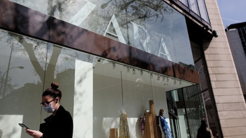 Una mujer con mascarilla pasa junto al escaparate de la tienda Zara, la principal enseña de Inditex, en Madrid. E.P./Eduardo Parra Una mujer con mascarilla pasa junto al escaparate de la tienda Zara, la principal enseña de Inditex, en Madrid. E.P./Eduardo Parra