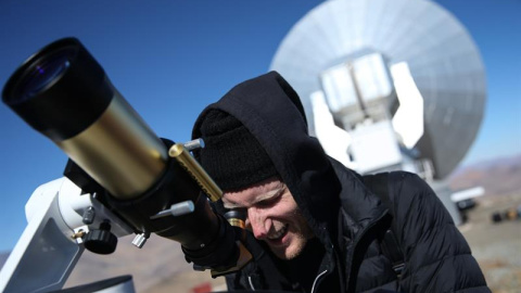 Un hombre observa el sol a través de un telescopio horas antes de que comience el eclipse solar total, este martes en el Observatorio de La Silla, situado en la región de Coquimbo (Chile). EFE