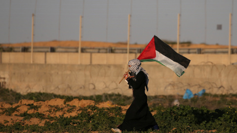 Una mujer con la bandera palestina en una protesta contra Israel en la frontera con Gaza. REUTERS/Ibraheem Abu Mustafa Una mujer con la bandera palestina en una protesta contra Israel en la frontera con Gaza. REUTERS/Ibraheem Abu Mustafa