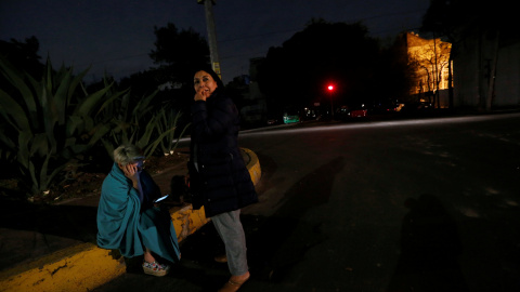 Dos personas esperan en la calle tras el fuerte sismo detectado en Ciudad de México. REUTERS/Claudia Daut