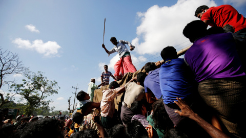 Un hombre usa una vara para controlar a la multitud mientras proporciona suministros de socorro a los refugiados Rohingya en el campamento de Cox, en Bangladesh. REUTERS / Mohammad Ponir Hossain Un hombre usa una vara para controlar a la multitud mientras proporciona suministros de socorro a los refugiados Rohingya en el campamento de Cox, en Bangladesh. REUTERS / Mohammad Ponir Hossain