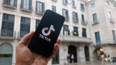 Un mòbil amb el logotip de TikTok davant de l'Ajuntament de Girona Un mòbil amb el logotip de TikTok davant de l'Ajuntament de Girona