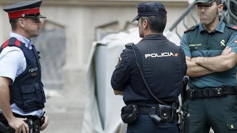 Un mosso, un policía nacional y un guardia civil vigilan el exterior del edificio de la Delegación del Gobierno en Catalunya, durante la reunión de coordinación de los cuerpos de seguridad sobre el 1-O. EFE/Andreu Dalmau Un mosso, un policía nacional y un guardia civil vigilan el exterior del edificio de la Delegación del Gobierno en Catalunya, durante la reunión de coordinación de los cuerpos de seguridad sobre el 1-O. EFE/Andreu Dalmau