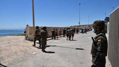 Militares del ejército español vigilan desde la playa la llegada de migrantes procedentes de Marruecos, a 19 de mayo de 2021, en Ceuta, (España). Militares del ejército español vigilan desde la playa la llegada de migrantes procedentes de Marruecos, a 19 de mayo de 2021, en Ceuta, (España).