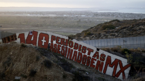 Una pintura que dice "140 periodistas asesinados en MX" en una sección de la valla fronteriza entre EE. UU. y México en Tijuana, en el estado de Baja California, México, en 2018 Una pintura que dice "140 periodistas asesinados en MX" en una sección de la valla fronteriza entre EE. UU. y México en Tijuana, en el estado de Baja California, México, en 2018