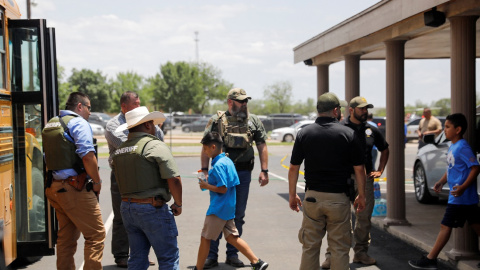 Los niños se suben a un autobús escolar mientras el personal policial vigila la escena de un presunto tiroteo cerca de la Escuela Primaria Robb en Uvalde, Texas, EE. UU. 24 de mayo de 2022. Los niños se suben a un autobús escolar mientras el personal policial vigila la escena de un presunto tiroteo cerca de la Escuela Primaria Robb en Uvalde, Texas, EE. UU. 24 de mayo de 2022.