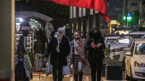 Mujeres palestinas pasen con mascarillas por las calles de Gaza. Mujeres palestinas pasen con mascarillas por las calles de Gaza.