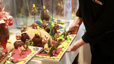 27-3-2023 Pla detall d'una treballadora d'una pastisseria de Barcelona col·locant una mona de Pasqua de xocolata a l'establiment 27-3-2023 Pla detall d'una treballadora d'una pastisseria de Barcelona col·locant una mona de Pasqua de xocolata a l'establiment