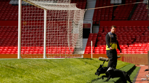 Un perro y su guía inspeccionan el estadio del Manchester United después de los miembros de seguridad ordenaran evacuar el estado por la presencia de un paquete sospechoso. REUTERS Un perro y su guía inspeccionan el estadio del Manchester United después de los miembros de seguridad ordenaran evacuar el estado por la presencia de un paquete sospechoso. REUTERS