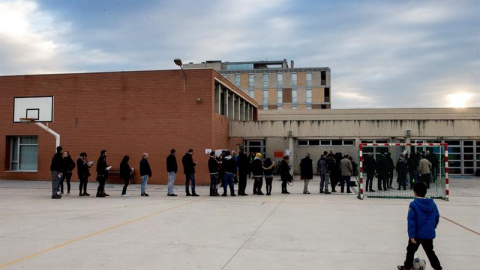Varias personas esperan la apertura del colegio Lluis Piquer en Parets del Vallés, Barcelona. / EFE