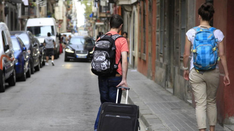 Dos personas con una maleta caminan por la calle. EFE Dos personas con una maleta caminan por la calle. EFE