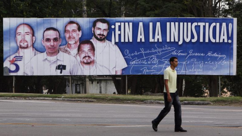 Un hombre camina frente a una valla con la imagen del llamado grupo de "Los Cinco" hoy, miércoles 17 de diciembre de 2014, en La Habana (Cuba). Un hombre camina frente a una valla con la imagen del llamado grupo de "Los Cinco" hoy, miércoles 17 de diciembre de 2014, en La Habana (Cuba).