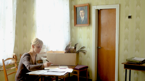 Una trabajadora del museo local de Guliai Pole bajo una foto de Néstor Majnó. Una trabajadora del museo local de Guliai Pole bajo una foto de Néstor Majnó.