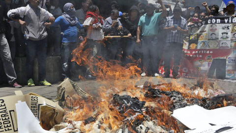 Maestros en huelga saquean varias mesas de votación para posteriormente quemar las urnas y los votos en el centro histórico de Oaxaca, al sur de México.- Mario Arturo Martínez (EFE) Maestros en huelga saquean varias mesas de votación para posteriormente quemar las urnas y los votos en el centro histórico de Oaxaca, al sur de México.- Mario Arturo Martínez (EFE)