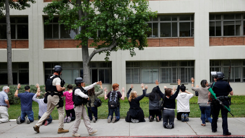 Police officers conduct a search on people at the University of California, Los Angeles (UCLA) campus after it was placed on lockdown following reports of a shooter that left 2 people dead in Los Angeles, California June 1, 2016. REUTERS/Pa