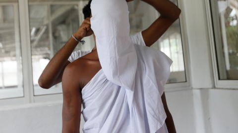 Un monje budista recién ordenado es preparado por otra persona durante una ceremonia de Upasampada, un rito budista por el que un novicio se convierte en un monje, o Bhikhu , en un templo budista en Colombo, Sri Lanka. REUTERS / Dinuka Liya
