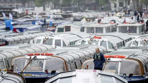 Vista general de varios barcos turísticos que bloquean uno de los canales de Ámsterdam, Holanda. EFE/Robin Van Lonkhuijsen