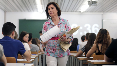 Una profesora repartiendo exámenes Una profesora repartiendo exámenes