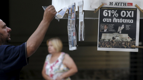 A man looks at newspapers showing the results of yesterday's referendum in central Athens, Greece, July 6, 2015. Greeks overwhelmingly rejected conditions of a rescue package from creditors on Sunday, throwing the future of the country's eu A man looks at newspapers showing the results of yesterday's referendum in central Athens, Greece, July 6, 2015. Greeks overwhelmingly rejected conditions of a rescue package from creditors on Sunday, throwing the future of the country's eu
