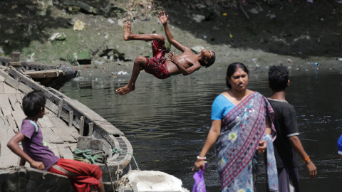 Un niño indio se lanza al río Adi Gaga en busca de monedas, en las proximidades del templo Kalighat en Calcuta, este de la India. EFE/Piyal Adhikary