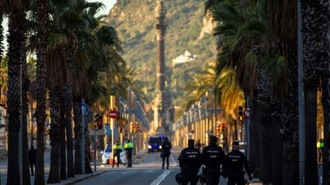 Miembros de las fuerzas de seguridad protegen el paseo de Colón, que aparece desierto, la zona más cercana a la Llotja de Mar de Barcelona. /EFE Miembros de las fuerzas de seguridad protegen el paseo de Colón, que aparece desierto, la zona más cercana a la Llotja de Mar de Barcelona. /EFE
