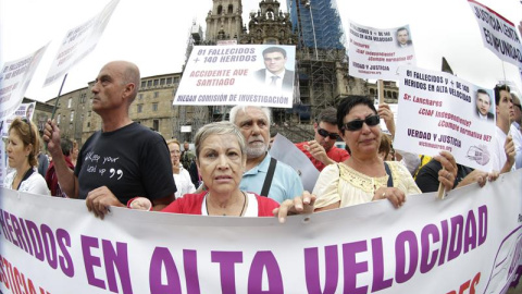 Víctimas de la tragedia ferroviaria de Angrois, (en primer plano una mujer que perdió una mano y sufrió quemaduras en la cara), se concentran ante la catedral, para reclamar una justicia más ágil y una comisión de investigación para saber "