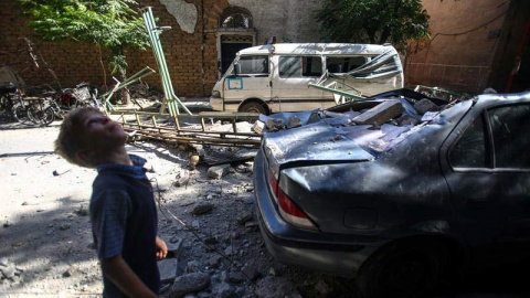 Un niño camina junto a vehículos y edificaciones dañados por un ataque aéreo hoy, jueves 21 de julio de 2016, en Douma (Siria), / EFE Un niño camina junto a vehículos y edificaciones dañados por un ataque aéreo hoy, jueves 21 de julio de 2016, en Douma (Siria), / EFE