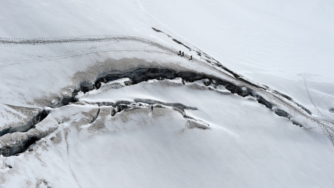 Varios escaladores caminan más cerca de las grietas en el glaciar des Géants (Glaciar de los Gigantes), junto al pico Aiguille du Midi en la montaña Mont-Blanc en Chamonix, al este de Francia. -AFP PHOTO / PHILIPPE DESMAZES