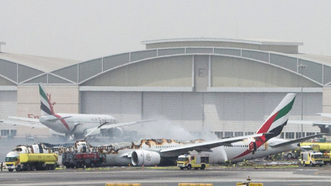 Los equipos de emergencia y los bomberos del Aeropuerto de Dubai rodean el aparato de Emirates Airline que se ha incendiado tras un aterrizaje de emergencia. REUTERS/Stringer