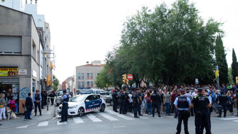 Mossos d'Esquadra controlan a la multitud que se ha congregado ante el domicilio en el que agentes de la Guardia Civil llevan a cabo un registro en Sabadell (Barcelona). /EFE Mossos d'Esquadra controlan a la multitud que se ha congregado ante el domicilio en el que agentes de la Guardia Civil llevan a cabo un registro en Sabadell (Barcelona). /EFE