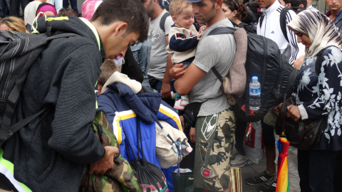 Hacen cola delante de la estación para ir al autobús que los llevará a Austria, sábado por la tarde./ C.T Hacen cola delante de la estación para ir al autobús que los llevará a Austria, sábado por la tarde./ C.T