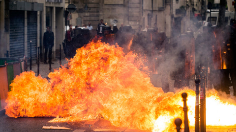 Un cóctel mólotov explota al lado de varios policías durante una manifestación contra la nueva reforma laboral en París.- EFE/Etienne Laurent