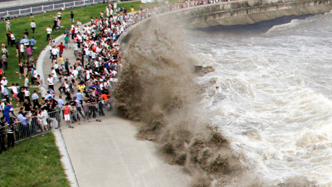 Enormes olas de la mar agitada hacen correr a los paseantes de Hangzhou, provincia de Zhejiang, China. REUTERS / Stringer,