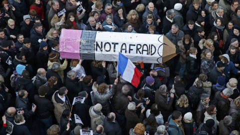 Citizens carrying a giant cardboard pencil reading "Not Afraid" take part in a Hundreds of thousands of French citizens solidarity march (Marche Republicaine) in the streets of Paris January 11, 2015. French citizens will be joined by dozen