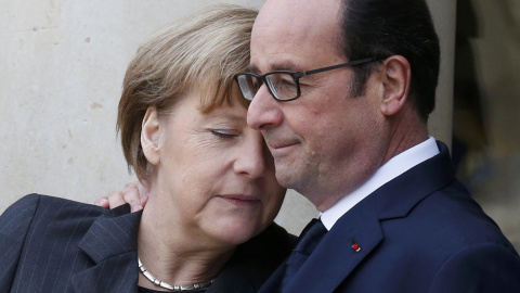 French President Francois Hollande (R) welcomes Germany's Chancellor Angela Merkel as she arrives at the Elysee Palace before the solidarity march (Rassemblement Republicain) in the streets of Paris January 11, 2015. REUTERS/Pascal Rossigno