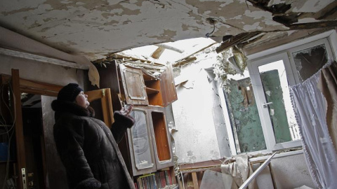 Una mujer observa su casa dañada tras un bombardeo en el distrito Petrovskiy de Donetsk, Ucrania, el 10 de febrero del 2015. Unidades de las Guardia Nacional apoyadas por efectivos del Ejército ucraniano se han hecho con el control de varia