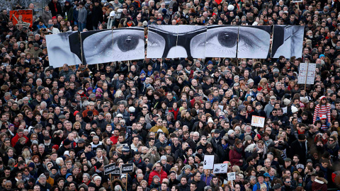 Manifestantes recrean con varios paneles los ojos del editor de Charlie Ebdo, Stephane Charbonnier, 'Charb', durante una marcha solidaria en las Calles de París. /YVES HERMAN (REUTERS)