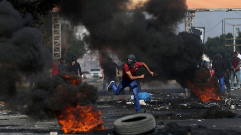 Manifestantes palestinos arrojan piedras a soldados israelíes cerca de Nablús. / AHMAD TALAT (REUTERS)