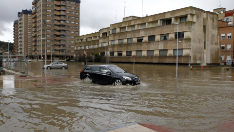 Un vehículo intenta circular por una calle de Miranda de Ebro que se encuentra anegada tras la crecida del río Ebro. -EFE/Santi Otero