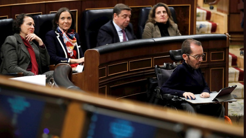 El diputado de Unidas Podemos, Pablo Echenique (d), sigue la intervención del candidato a presidente del Gobierno, Pedro Sánchez, en el Congreso de los Diputados durante la primera jornada de su investidura como presidente del Gobierno. EFE