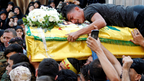 Un hombre llora sobre el ataúd de un soldado de Hezbollah fallecido en Alepo, durante su funeral en Beirut. /REUTERS