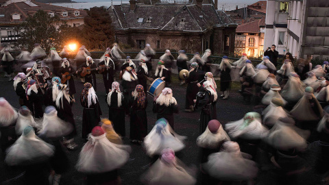 Varias mujeres vestidas de lamias, cantan y bailan durante el carnaval de Mundaka. /VICENTE WEST (REUTERS)