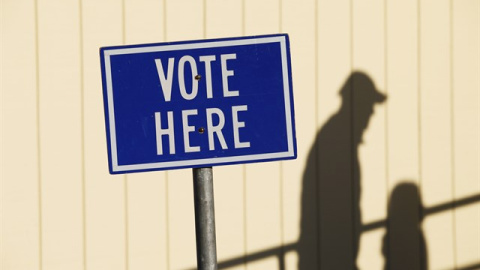 Cartel que indica donde votar. "Vote here", vote aquí. / REUTERS Cartel que indica donde votar. "Vote here", vote aquí. / REUTERS