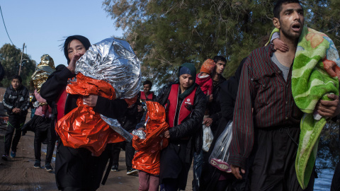 Familias de refugiados sirios, recién llegados a las costas griegas desde Turquía, caminan hasta el campamento de Kara Tepe, en la isla de Lesbos.- SANTI DONAIRE / NERVIO FOTO