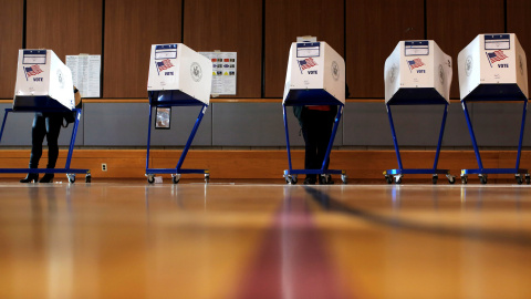 Varios votantes preparan su voto en las cabinas de un colegio electoral en el barrio neoyorquino de East Harlem. REUTERS/Andrew Kelly Varios votantes preparan su voto en las cabinas de un colegio electoral en el barrio neoyorquino de East Harlem. REUTERS/Andrew Kelly