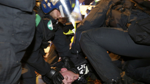 Detienen a un partidario del grupo activista Anonymous en la protesta en Londres, Gran Bretaña 5 de noviembre de 2015. Miles de manifestantes participaron en la marcha 'Million Mask' en la capital el jueves . REUTERS / Stefan Wermuth
