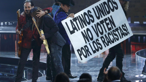 Los artistas mexicanos, tras su actuación conjunta sobre el escenario del Grand Garden Arena del hotel y casino MGM de Las Vegas (Nevada), sacaron una pancarta con el lema: "Latinos unidos. ¡No voten por los racistas!".- REUTERS.
