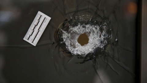 Agujero producido por una bala en el cristal del pub de Tel Aviv donde un desconocido abrió fugo, matando a dos personas e hiriendo a otras siete. REUTERS/Baz Ratner